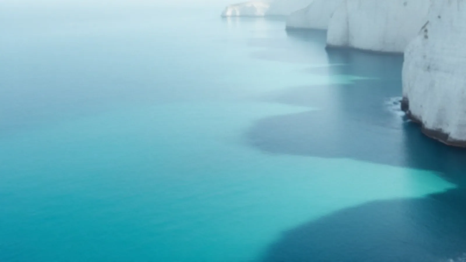 Pale ivory sea cliffs above clear turquoise water in soft morning light, the FinanceIvory view of online loans with clear terms, $100 – $5,000